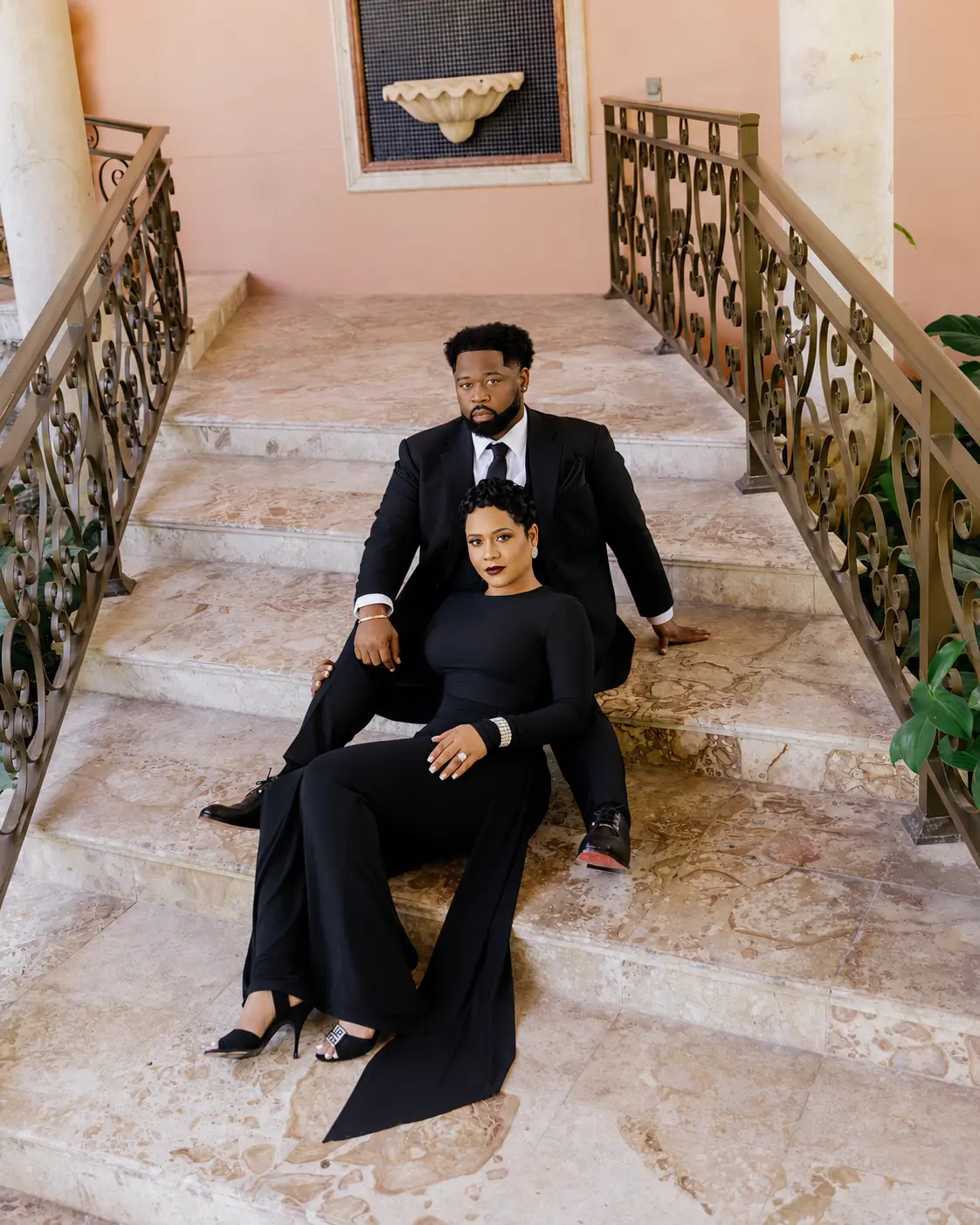 Lathario and Drew seated together on marble stairs